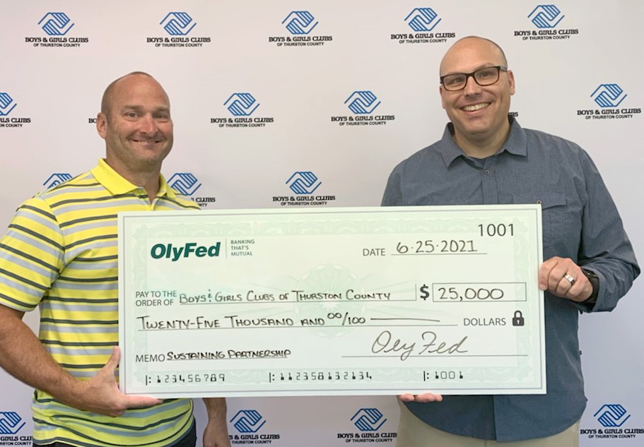 Ryan Betz, OlyFed VP of Marketing and Public Relations Presents Sustaining Partnership Donation to BGCTC CEO, Chris Woods.